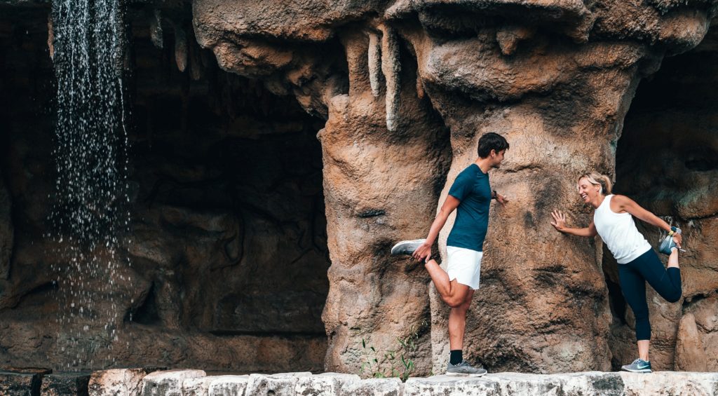 A couple warming up under a cliff